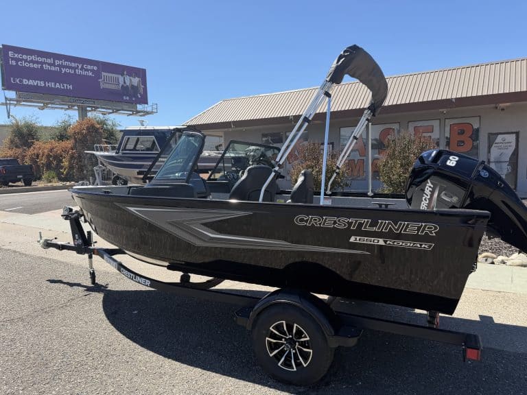 New Crestliner 1650 Kodiak fishing boat on trailer at dealership.