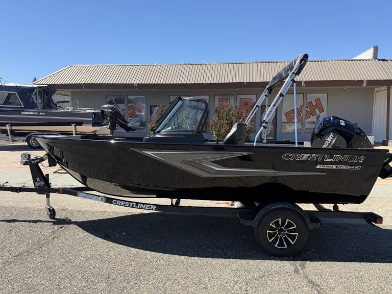 New Crestliner 1650 Kodiak fishing boat on trailer at dealership.