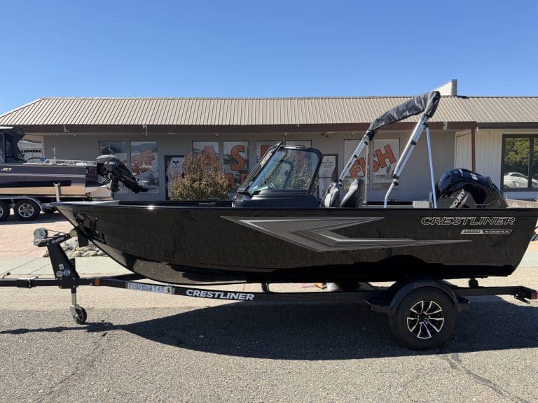New Crestliner 1650 Kodiak fishing boat on trailer at dealership.