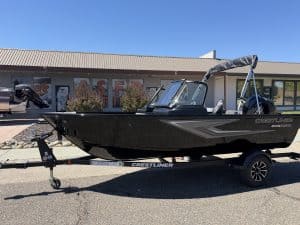New Crestliner 1650 Kodiak fishing boat on trailer at dealership.