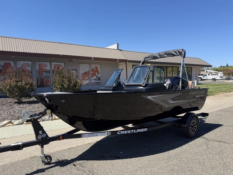 New Crestliner 1650 Kodiak fishing boat on trailer at dealership.