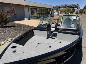 New Crestliner 1650 Kodiak fishing boat with spacious deck and windshield.