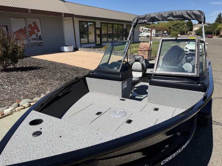 New Crestliner 1650 Kodiak fishing boat with spacious deck and windshield.