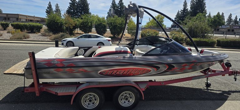 Speedboat on trailer with sleek design and vibrant graphics.