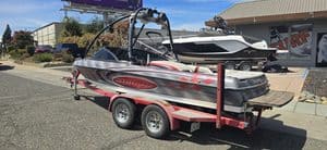 Speedboat on trailer at ASFB Marine with clear blue sky background.