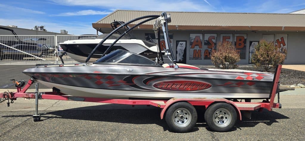 Speedboat on trailer at ASFB Marine with clear blue sky background.