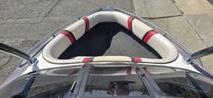 Close-up of boat seating area with cushioned seats and safety rails.