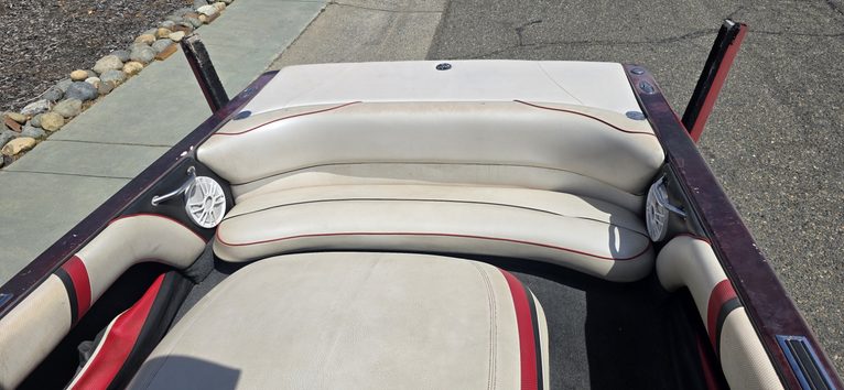 Close-up of boat seating with cushioned seats and console handles.