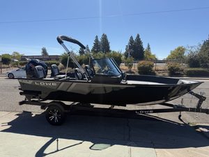 Lowe FM 1775 WT fishing boat with Mercury 115HP engine on trailer.