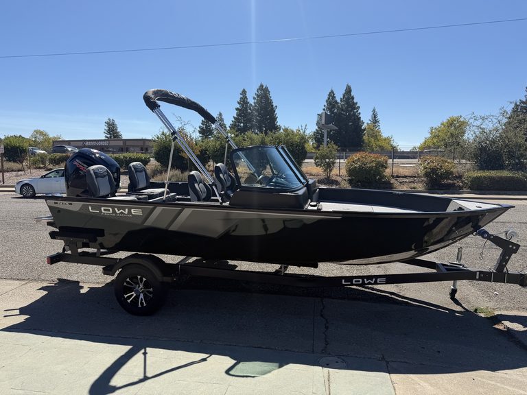Lowe FM 1775 WT fishing boat with Mercury 115HP engine on trailer.