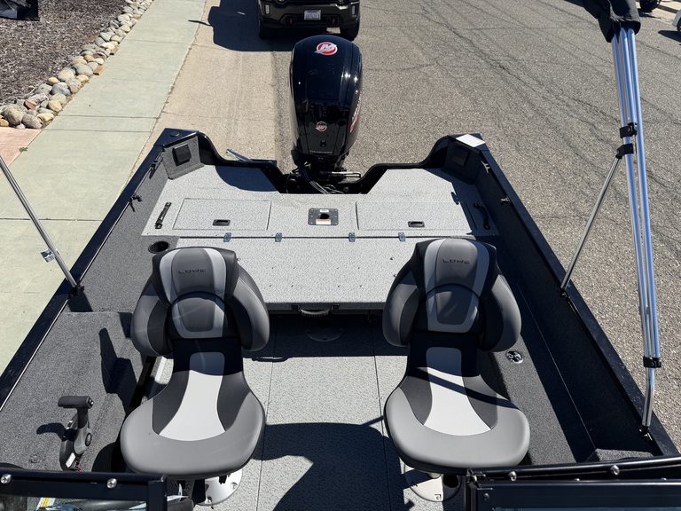 Fishing boat interior with two seats and outboard motor.