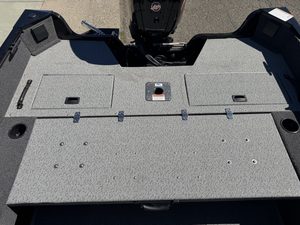 Fishing boat deck with storage compartments and Mercury 115HP Pro Xs engine.