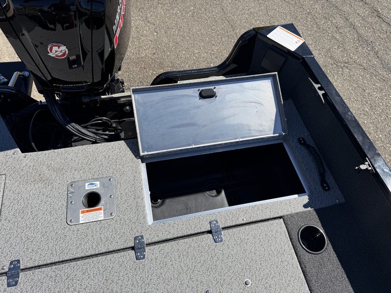 Boat storage compartment with lid open on Lowe FM 1775 WT boat.