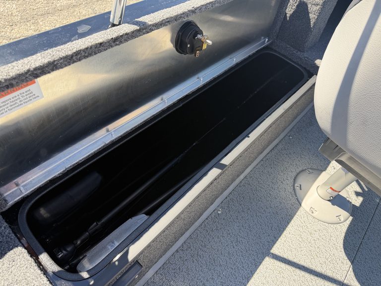 Boat storage compartment with rod holders and electrical outlet.