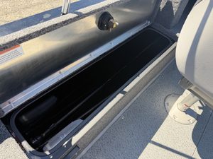 Boat storage compartment with rod holders and electrical outlet.
