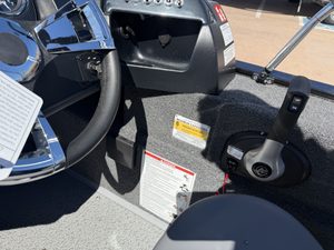 Boat interior with steering wheel and control panel at ASFB Marine.