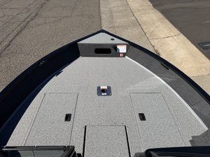 Boat deck with storage compartments and fishing accessories.