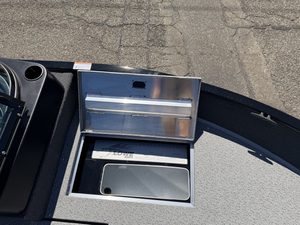 Boat storage compartment with lid open on Lowe FM 1775 WT boat.