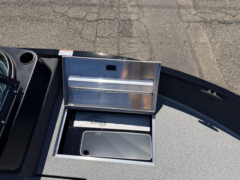 Boat storage compartment with lid open on Lowe FM 1775 WT boat.