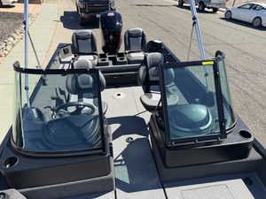 Bass boat with Mercury 115HP engine and dual windshields for fishing.