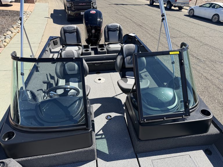 Bass boat with Mercury 115HP engine and dual windshields for fishing.
