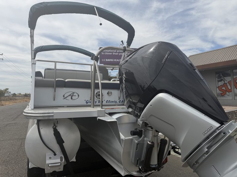 2022 Avalon Cata pontoon boat with outboard motor and canopy.