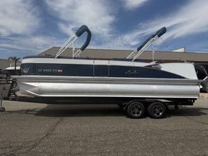 Luxury Avalon Catalina pontoon boat on trailer at marina.