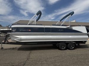 Luxury Avalon Catalina pontoon boat on trailer at marina.