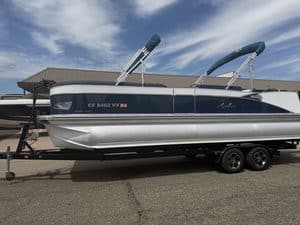 Luxury Avalon Catalina pontoon boat on trailer at marina.