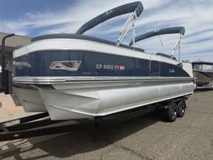 Luxury Avalon Catalina pontoon boat on trailer with blue and white exterior.