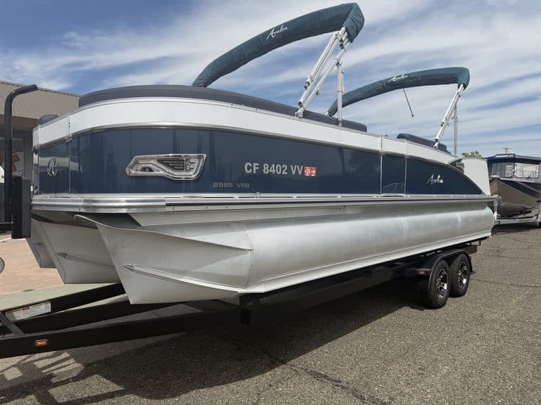Luxury Avalon Catalina pontoon boat on trailer with blue and white exterior.