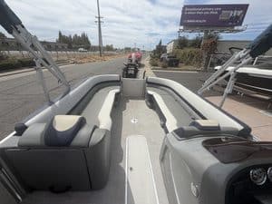 Pontoon boat on display at ASFB Marine with seating and steering console.