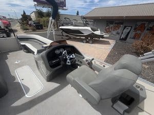 Luxury Avalon Cata pontoon boat with steering console and seating.