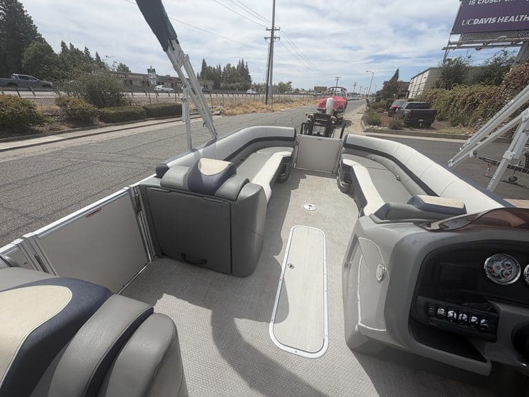 Interior view of a 2022 Avalon Cata pontoon boat with seating and steering console.