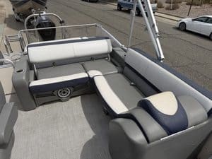 Pontoon boat with seating and steering console on watercraft.