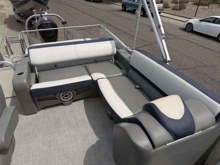 Pontoon boat with seating and steering console on watercraft.