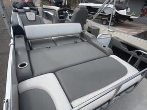 Comfortable boat seating area with gray and white cushions on Avalon Cata model.