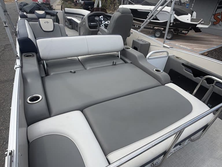 Comfortable boat seating area with gray and white cushions on Avalon Cata model.
