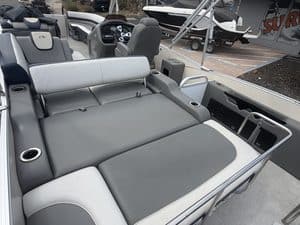 Luxury pontoon boat interior with spacious seating and modern controls.