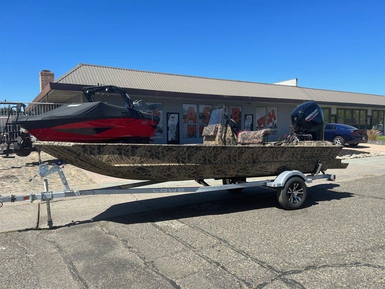Lowe RX 1860 80HP jet boat on trailer outside ASFB Marine store.