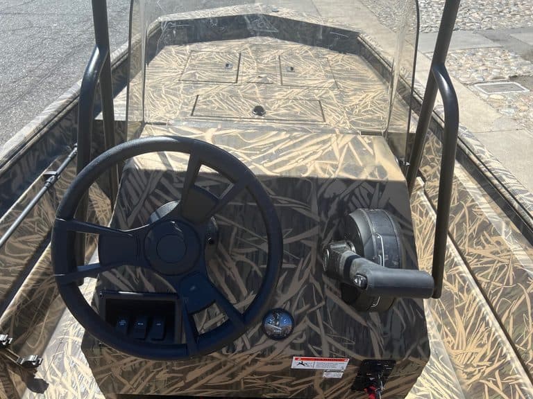 Interior view of Lowe RX 1860 jet boat with steering wheel and controls.