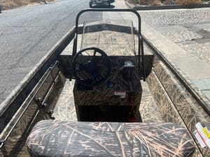 Lowe RX 1860 jet boat with camouflage interior and steering wheel.