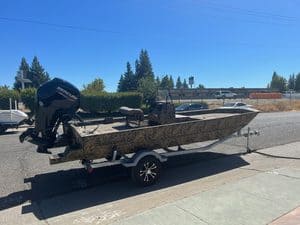 Lowe RX 1860 jet boat with Mercury outboard engine on trailer.