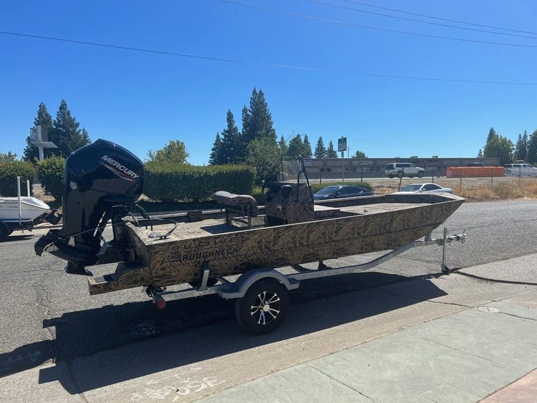 Lowe RX 1860 jet boat with Mercury outboard engine on trailer.