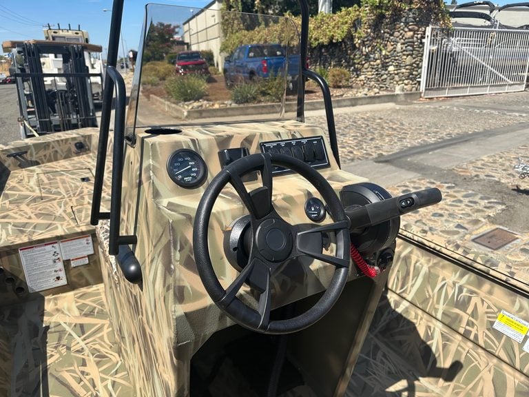 Close-up of utility vehicle dashboard with steering wheel and gauges.