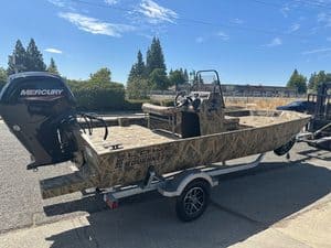Lowe RX 1860 boat with Mercury outboard motor on trailer.