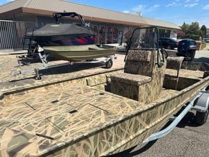 Lowe RX 1860 jet boat with camouflage pattern and seating.