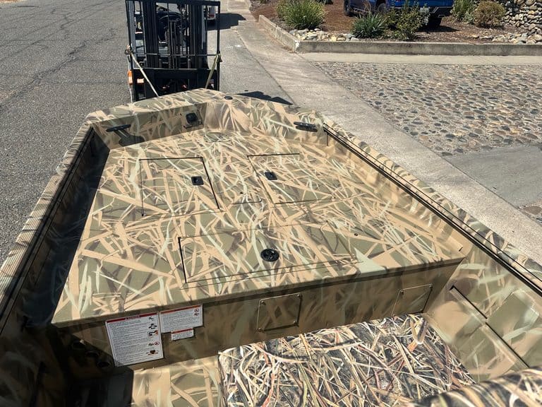 Camouflage boat deck with textured surface and mounting points.