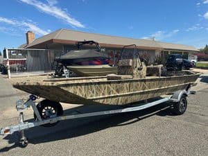 Lowe RX 1860 80HP jet boat on trailer in front of a house.