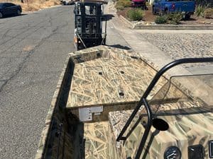 Camouflage aluminum boat with steering console and safety rail at ASFB Marine.